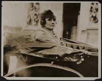 blow ups of 3x5 photo of Peggy in WWI uniform and a man and a woman in a car (2 copies)