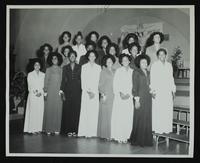 Unidentified group of nineteen debutantes arranged in three rows to right of stairs to stage with Links sign hanging in rear