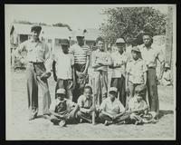 Baseball - Unidentified group of nine boys (with bats and gloves) and two men