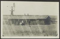 Family Standing in Front of Sod House