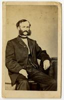 Portrait of a sitting man with mutton chops and a mustache
