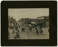 Parade scene of men on horses, buggies, and boys on bikes (Grand Army of the Republic leading the procession) (Semi-Centennial Parade)