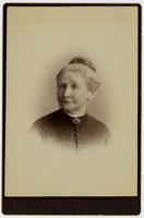 Portrait of an old woman with a high bun and button-up blouse