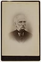 Portrait of an old man with sideburns, mustache, and black tie