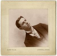 Portrait of a young man with an embroidered tie and no facial hair, image in corner rather than on edge