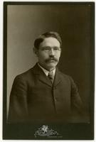 Portrait of a man with mustache and glasses