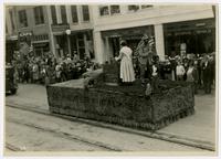 People dressed as pioneers float (75th Anniversary Historic Parade)