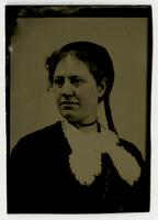 Portrait of  a woman with a long curl, choker, and furry collar piece