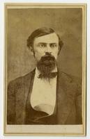 Portrait of a man with dark hair, beard, and mustache