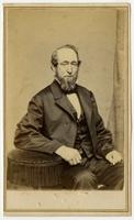 Man posing with round fringed armrest