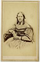 Portrait of a woman in a light textured dress and dark bordering