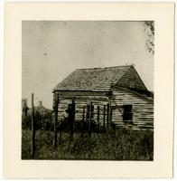 Log House with Windmill in Background