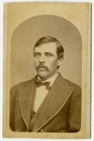 Portrait of a man with a mustache and a striped suit jacket