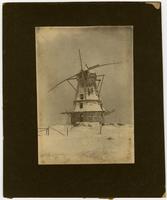 Windmill - Front view in snow showing house and valley