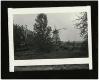 Windmill - Front view with trees and broken bridge in foreground