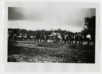 Workcrew walking down street carrying shovels