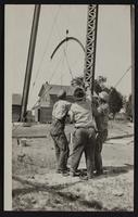 Workmen putting up steel water tank at Altoona, Kansas