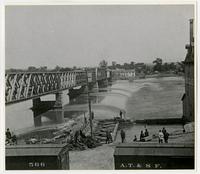 Toll bridge and dam with crowd watching by mill (1876 Flood)
