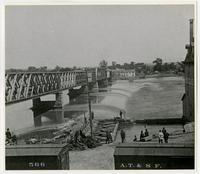 Toll bridge and dam with crowd watching by mill (1876 Flood)