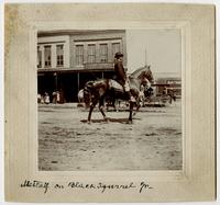 General W. S. Metcalf with Black Squirrel, Jr. [horse] on Massachusetts Street