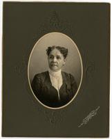 Portrait of an old woman with short, dark, curly hair