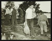 Men sandbagging by railroad tracks (1951 Flood)