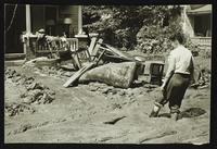Woman surveying flood damage to house (1951 Flood)