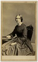 Portrait of sitting woman on black carved chair