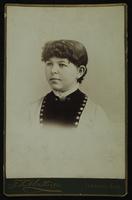 Portrait of a young girl with a frilly collar and black and white dress