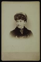 Portrait of a woman with a hat and curly bangs