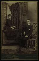 Photo of two children sitting with wood furniture