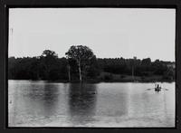 People rowing on lake