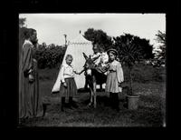 Girls with donkey near tent