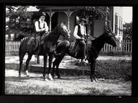 Cowboys(?) on horseback