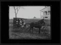 Children and man (Kansas State Penitentiary guard?) in surrey