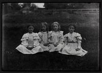 Four girls sitting on grass
