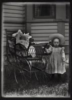 Girl and baby in baby carriage