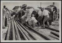 Auto Wrecks - Collision victims thrown from car onto ground beneath pipes.