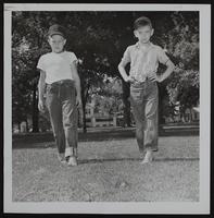 Gary Ray Dennis Greenfield (right) watch for broken glass as they walk barefooted.
