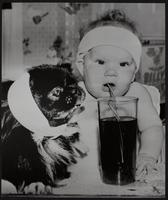 One way to beat the heat. little Georgeann Levon of Pottstown PA and her dog, Mike, wrap in wet towels and drink.