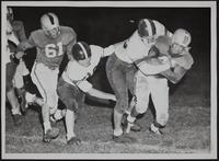Haskell Football - Frank Wesho (Right) tackled by Osage City's Nick Aguirre; (left) Al Nephew; and Bill Jones, Osage City.
