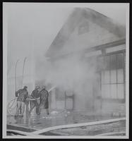 Fires - Tonganoxie - where three children died - Children of Mrs. and Mr. Richard Skaggs. (A) General view of rear of building. (B) Fred Needham looks over Skaggs bedroom. (C) Tonganoxie, Linwood and Basehor firemen and front of building in Downtown. (D) view of front of building.