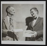 Newton Jerome (left) presents check to Luther Sumner of Local Eagles Lodge for cancer fund.
