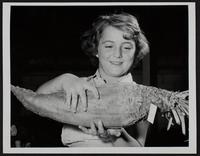 Douglas County Fair - Big Springs - Joan Wulfkuhle examines Mangel Beet.