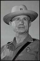 New Head Gear for Chief. Straw Hat is worn by the first division chief of Kansas Highway Patrol, E. P. Moomau.