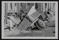 Truck accident at Winter Chevrolet - George Alexander with shovel, and Cecil Ray.