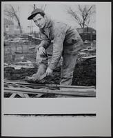 Weather - muddy conditions - Robert Shelling cleaning mud.