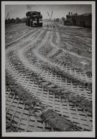 Tracks of machines working on fill at east side of bridge north of Lawrence.