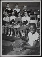 Lawrence All-School Music Festival - Leonard Vann with homemade drum - with vocal group - front (L to R) Tyson Travis, Cordley; Mary Lee Robins, centennial; Diane Thomas, New York; Karen Kolars, Woodlawn-Lincoln; Back row - Terry Turner, East Heights; Pamela Masters, Hillcrest; Carol Sullivan, McAllister.