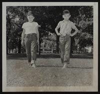 Gary Ray Dennis Greenfield (right) watch for broken glass as they walk barefooted.